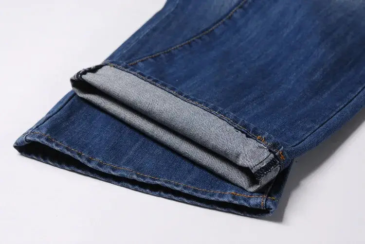 Men’s flared denim jeans bootcut casual pants in dark blue with faded inner lining and visible stitching.