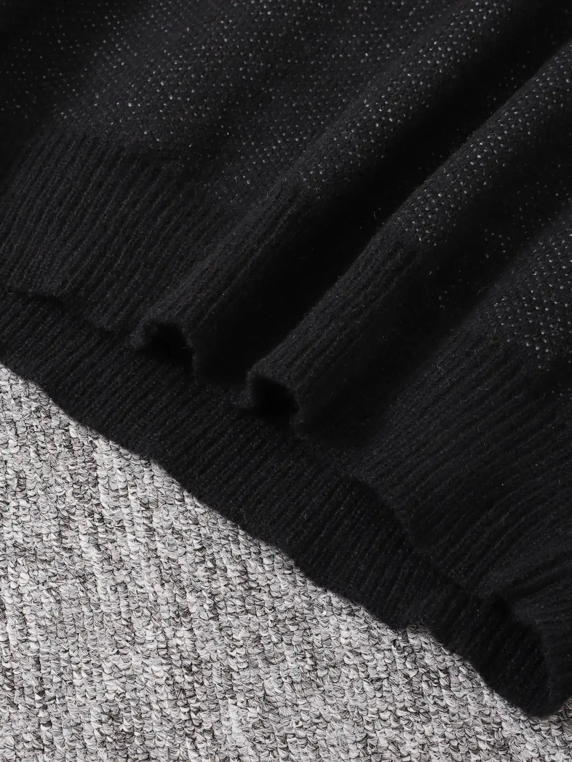 Men black amazing graphic knit sweater featuring a black knitted material with a ribbed hem and subtle textured pattern.
