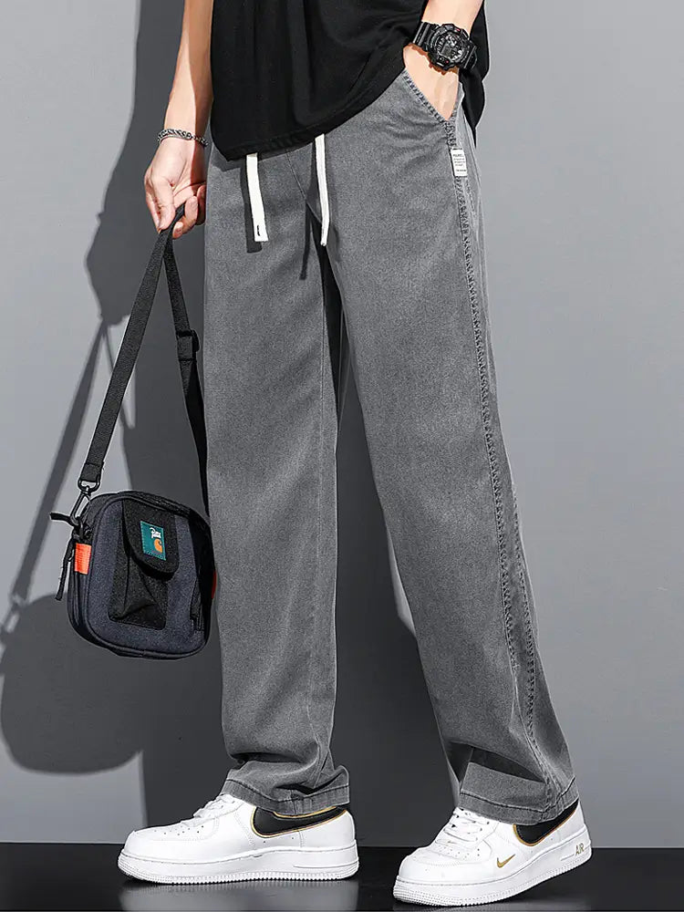 Men’s lyocell casual loose straight gray corduroy joggers with white drawstrings and a small brand tag on the side seam.