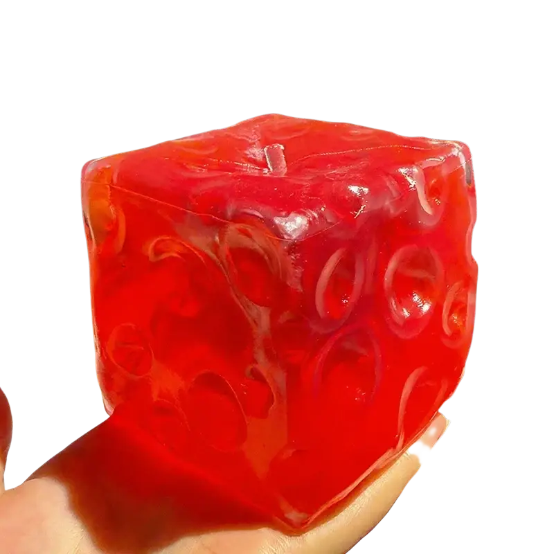 Vibrant red translucent cube shaped vaseline cheese squishy with swirling patterns front view for cheese squishy stress