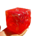 Vibrant red translucent cube shaped vaseline cheese squishy with swirling patterns front view for cheese squishy stress