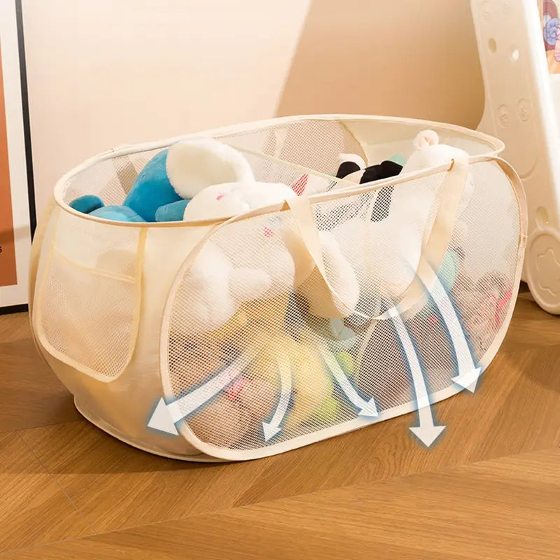 Beige mesh toy storage basket with large capacity collapsible design and sturdy handles filled with stuffed toys.
