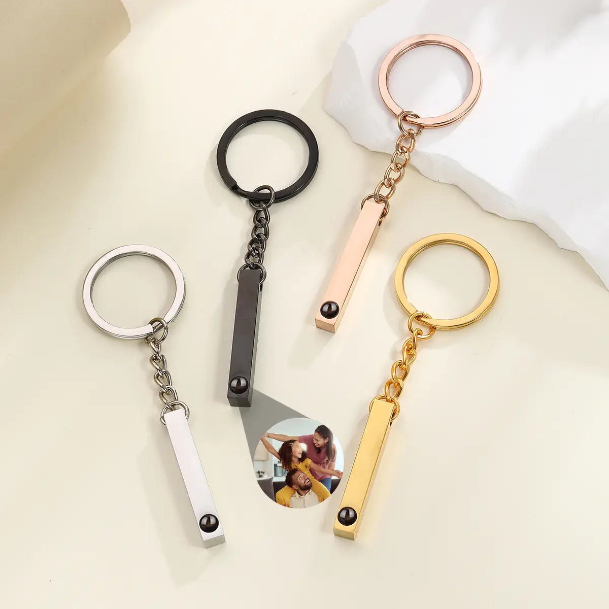 set of four sleek rectangular metal custom photo projection keychains in silver black rose gold and yellow gold finishes personalized memorial gift