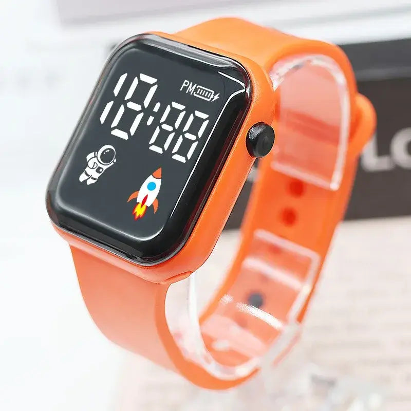 Montre électronique orange vif pour enfants, garçons et filles, avec écran noir affichant des icônes liées au temps et à l’espace, conçue pour les enfants, garçons et filles.