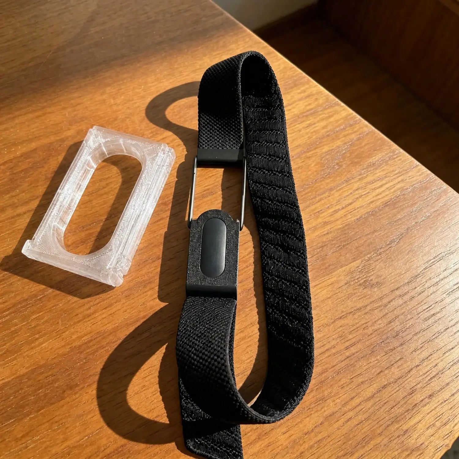 Black woven strap adapter bracket frame for Fitbit Air with sleek magnetic clasp and matching black plastic end pieces.