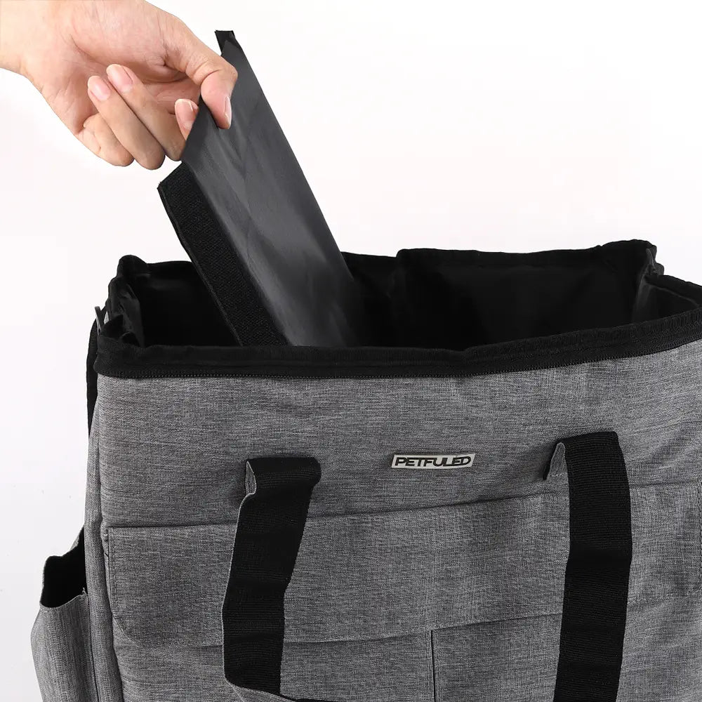 Sac de voyage pour chien en tissu gris chiné, avec fermeture éclair, sangles noires et écusson logo petfuled.