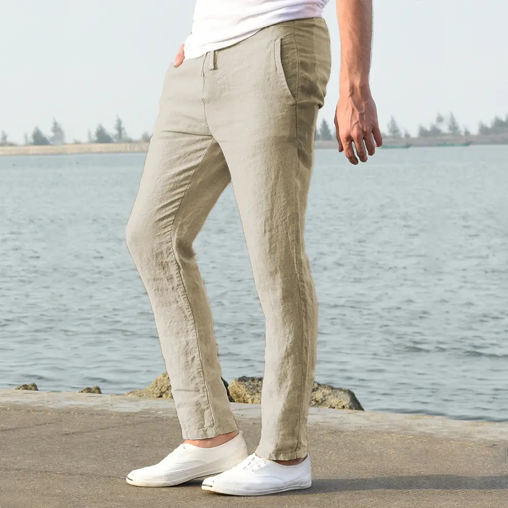 Beige slim fit men cotton linen trousers with breathable fabric and subtle texture for casual wear.