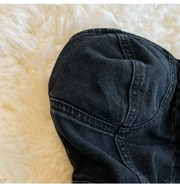 Denim jumpsuit off shoulder summer romper with a dark-wash denim cap featuring visible stitching and a slightly worn texture.