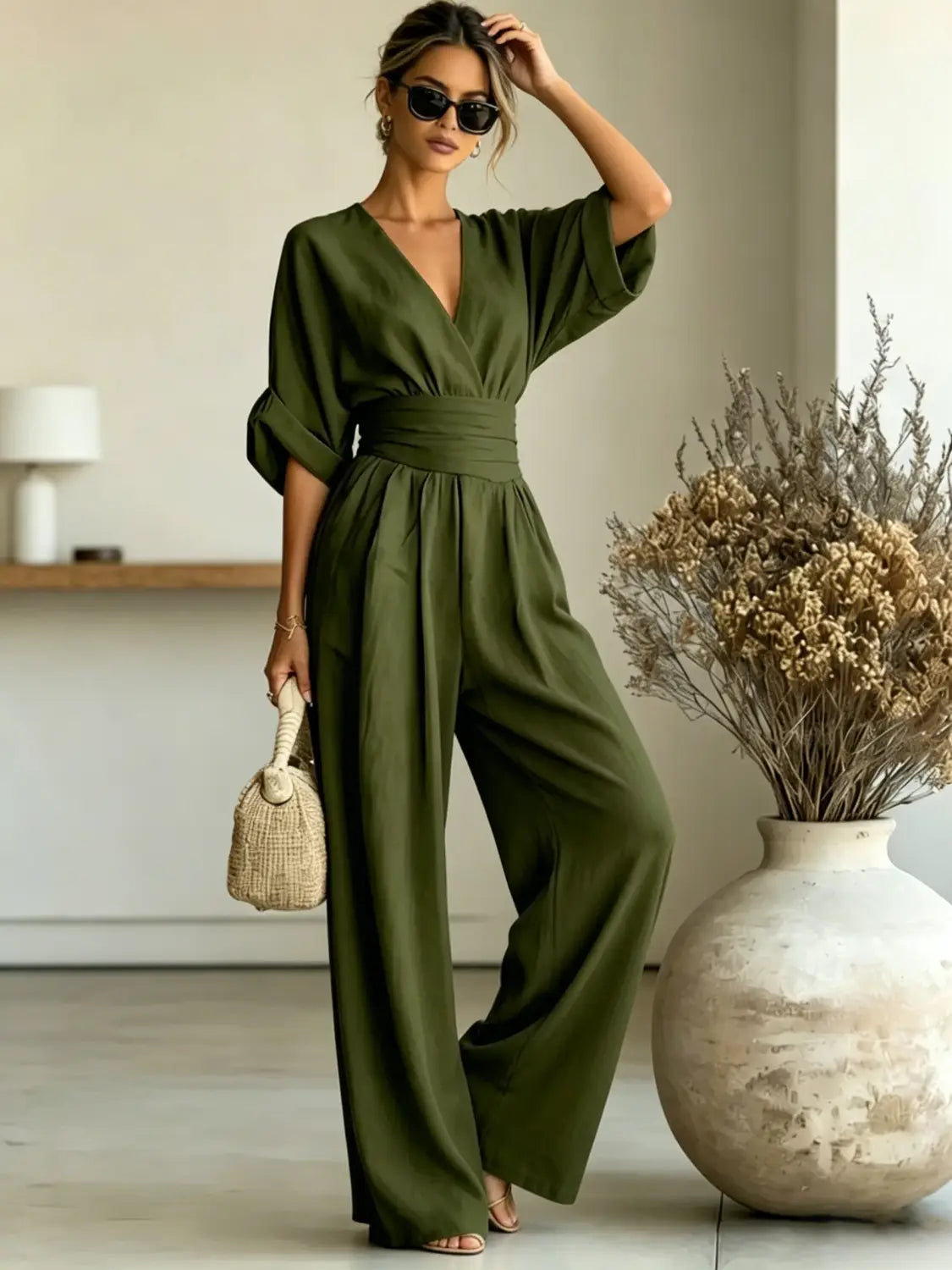 olive green wide-leg jumpsuit with v-neckline and cinched waistband made from lightweight fabric for comfortable all-day wear
