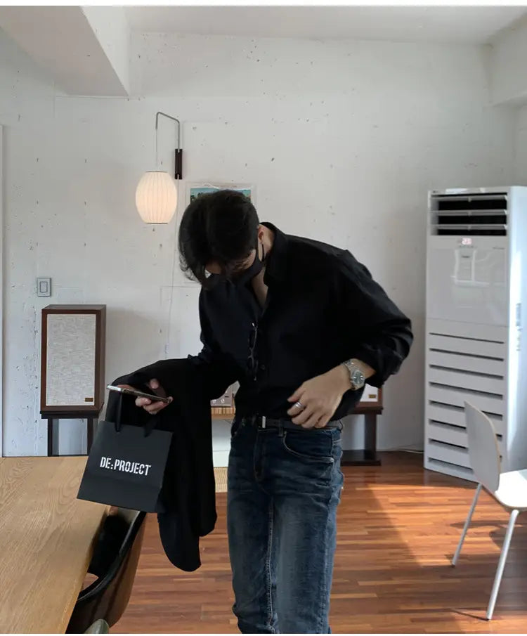 a black fabric shopping bag with white de project branding for a men black long sleeve casual button down shirt product