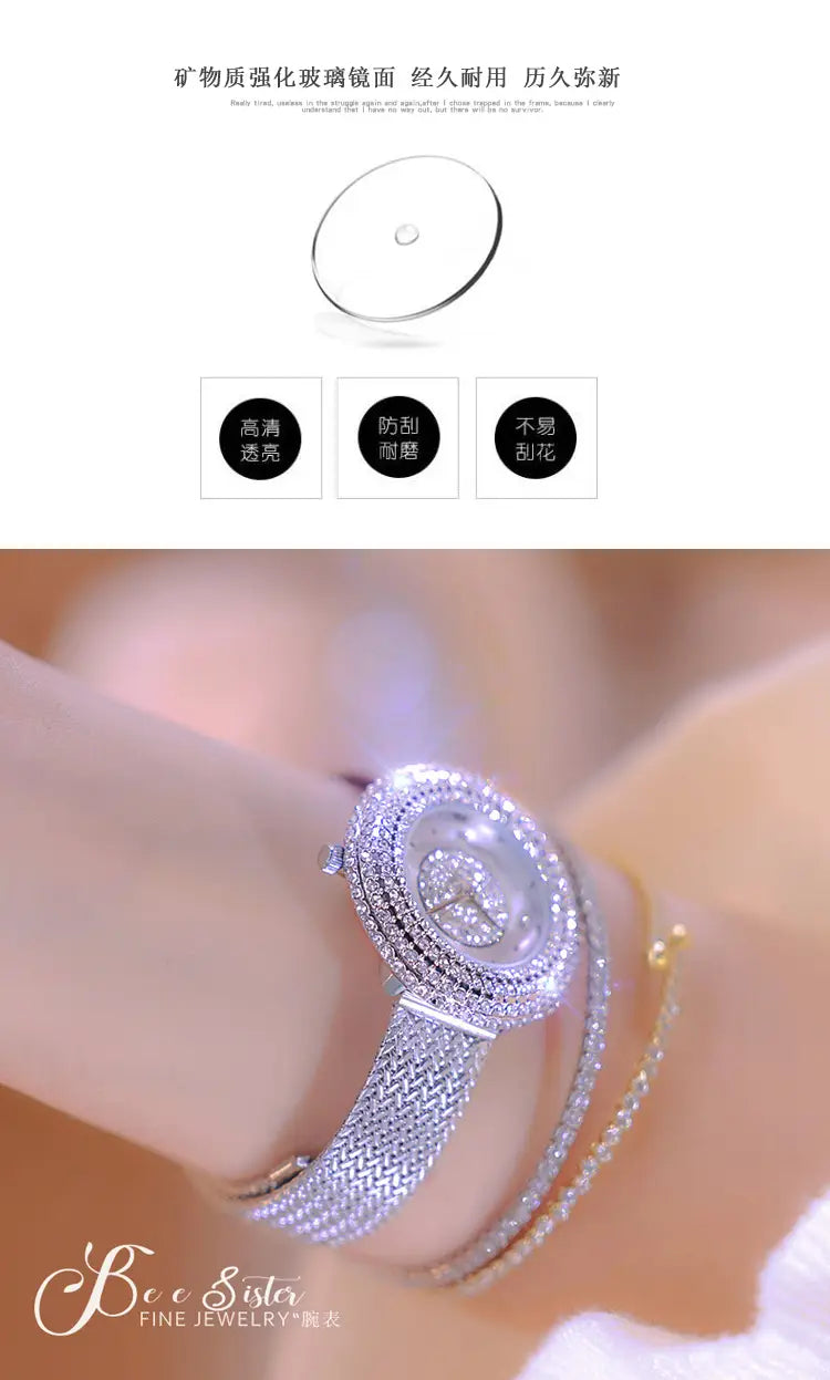 A sparkling silver diamond-encrusted luxury women watch with a textured mesh band worn on a wrist.