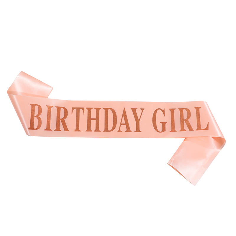 Una banda/faja de satén rosa suave con la inscripción "birthday girl" impresa en letras color rosa oro, del conjunto de tiara y banda con pedrería para chica de cumpleaños.