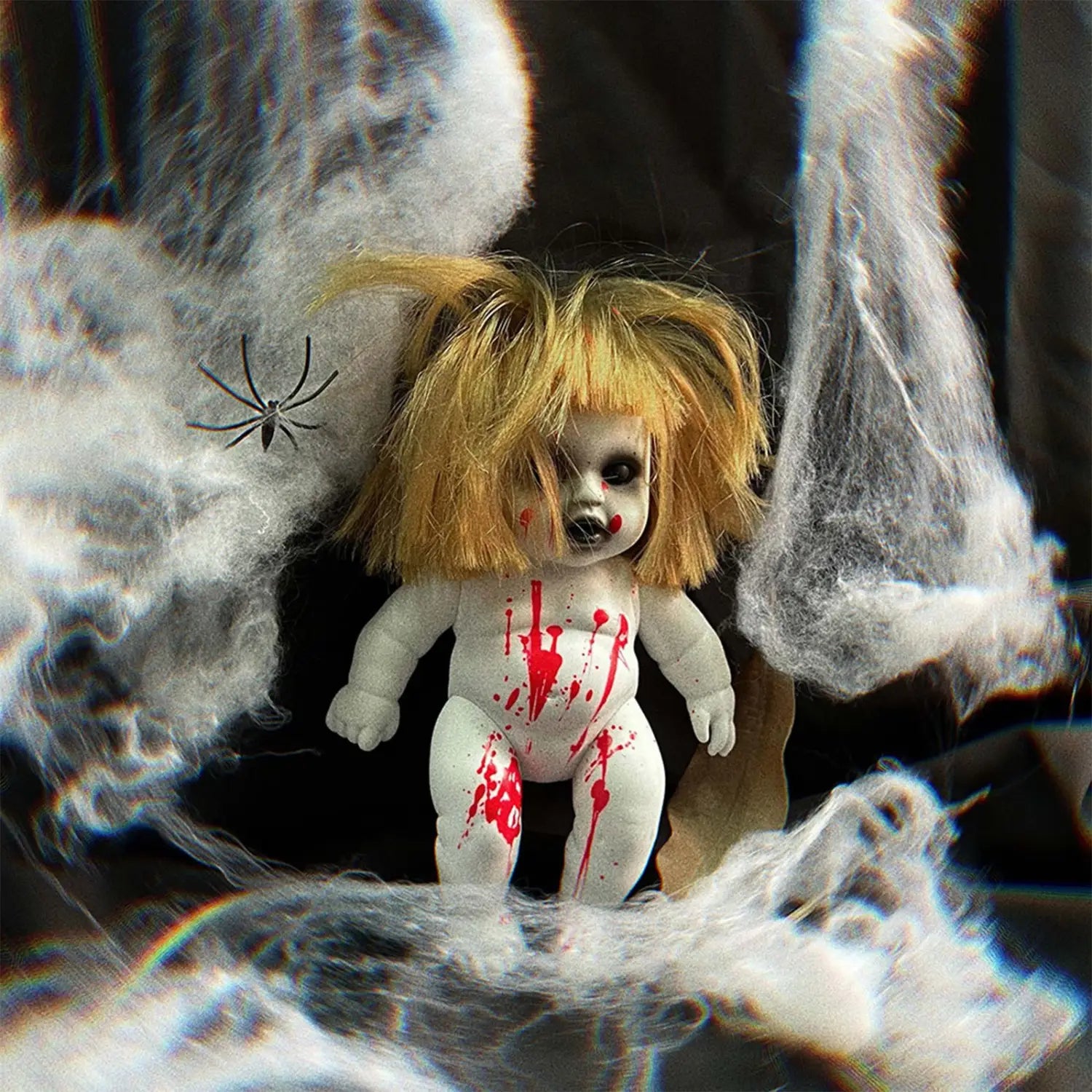 a creepy white porcelain halloween hanging ghost doll with blonde pigtails and red splatters surrounded by fake spiderwebs for spooky decoration