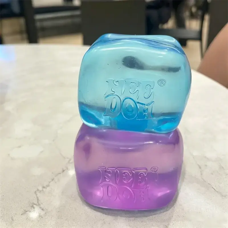Two translucent cube-shaped kiehl’s doterra scented gel bars stacked blue top and purple bottom front view