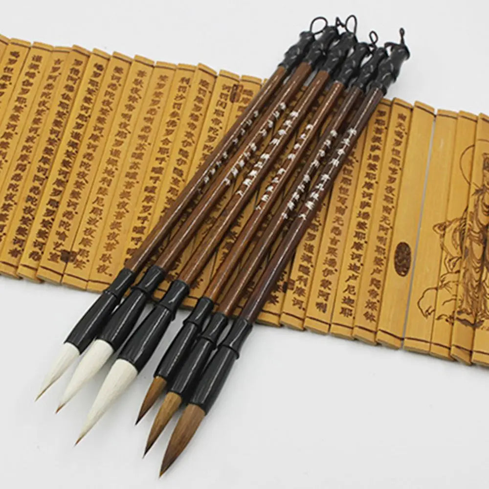 Set of six traditional Chinese calligraphy brushes with dark brown wooden handles black ferrules and white or natural bristles for writing practice.