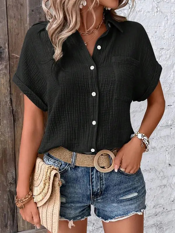 Women cotton short sleeve button up shirt in black textured ribbed fabric with white buttons.