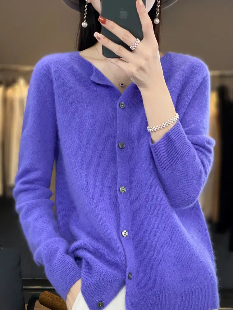 A soft vibrant purple merino wool cardigan for women featuring cashmere knit fabric with a classic button-front design and ribbed cuffs.