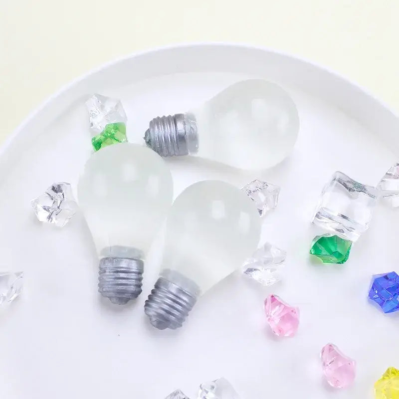 frosted glass light bulb-shaped ice cubes with metallic screw bases as light bulb squeeze toy sensory fidget stress relief
