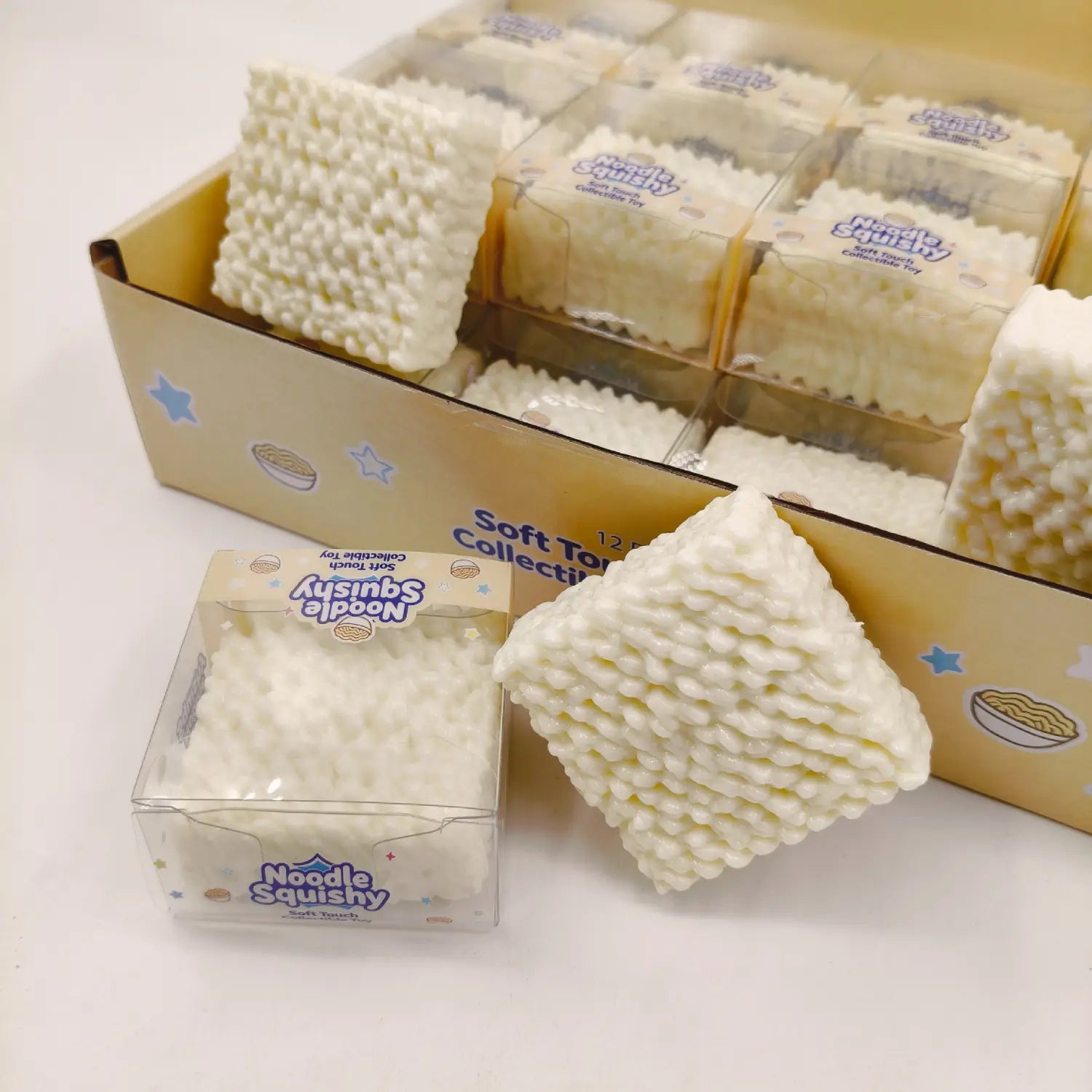 White square-shaped instant noodle squishy toy stress relief building block with a textured surface resembling noodles.