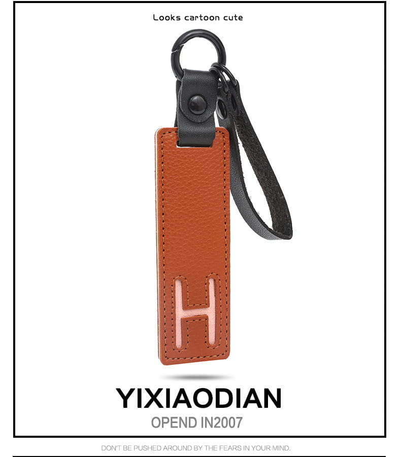 Brown leather letter keychain with embossed pink letter h, black strap, and metal ring ideal as an alphabet pendant party gift.