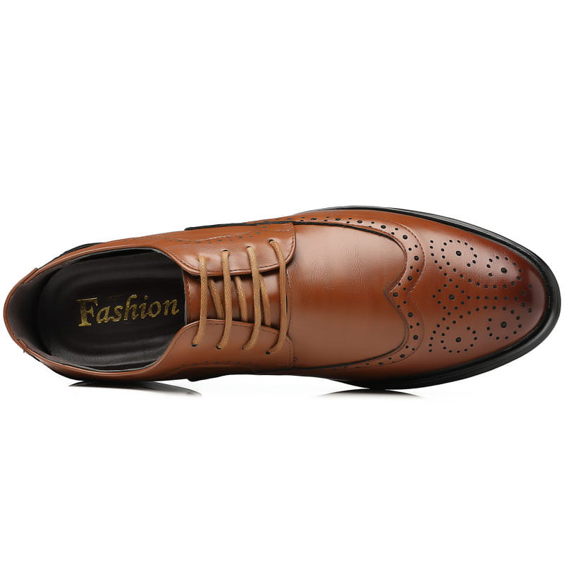 Men’s leather brogue dress shoe in brown with perforated detailing and a black sole.