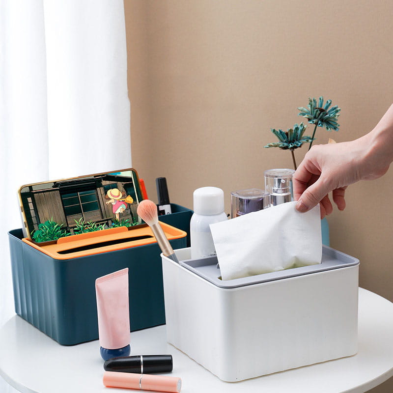 white rectangular plastic tissue box with gray rim and slanted front opening as part of a multi compartment plastic desk organizer