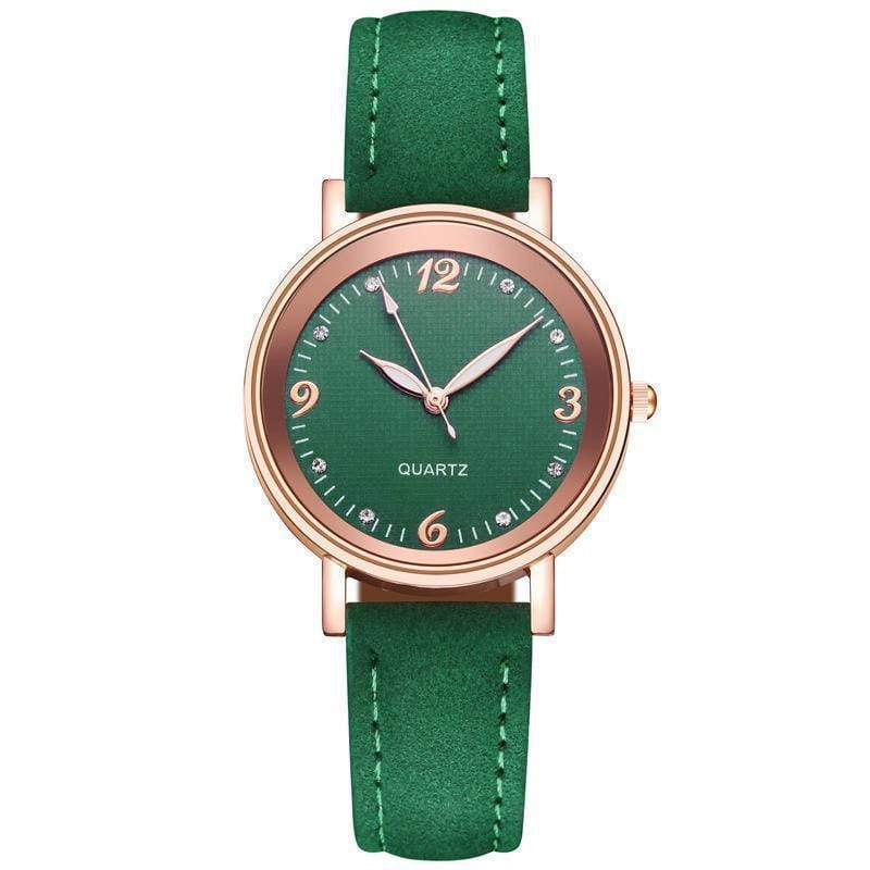 Women quartz watch with emerald green suede strap rose gold tone case and diamond accents on the dial.