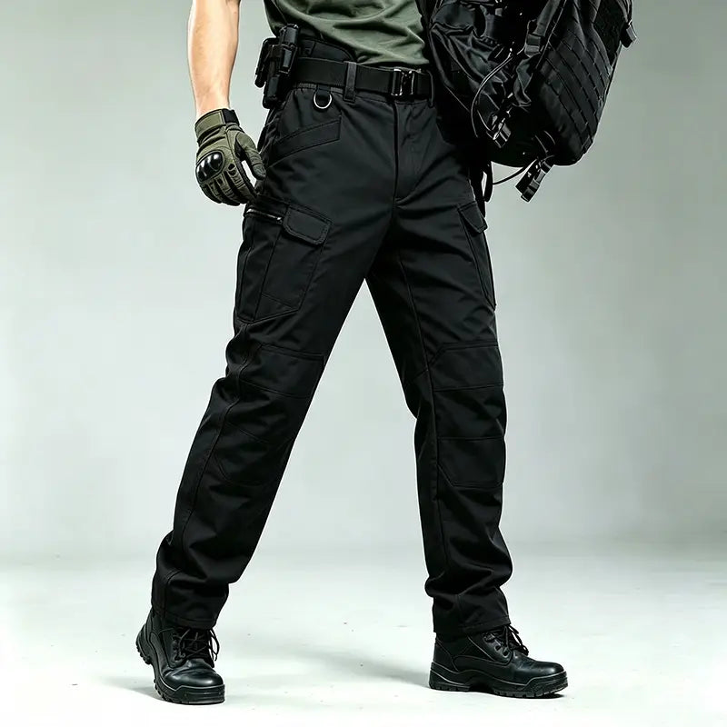 Men winter tactical cargo pants in black with multiple cargo pockets and reinforced stitching designed for waterproof hiking trousers.