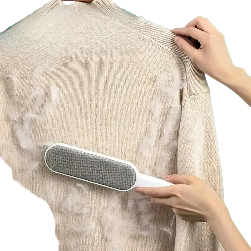 White-handled double-sided pet hair remover with gray textured scraping surface for manual hair ball cleaning