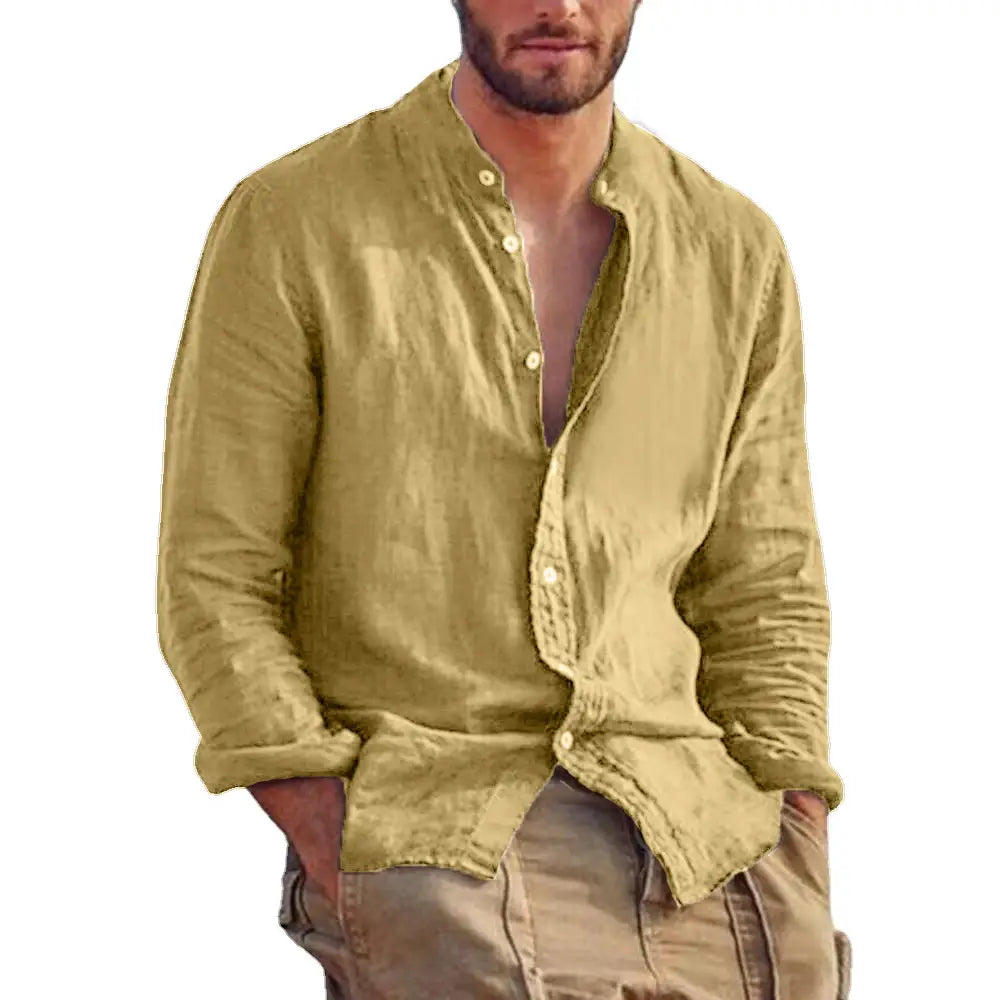A man wearing a light olive green men’s linen long sleeve stand collar casual shirt with a button-down front and rolled-up cuffs.