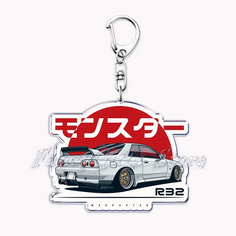 White Nissan Skyline R32 with gold rims on a clear acrylic keychain featuring red Japanese text and a silver metal clasp for the Nissan Skyline acrylic car keychain product.