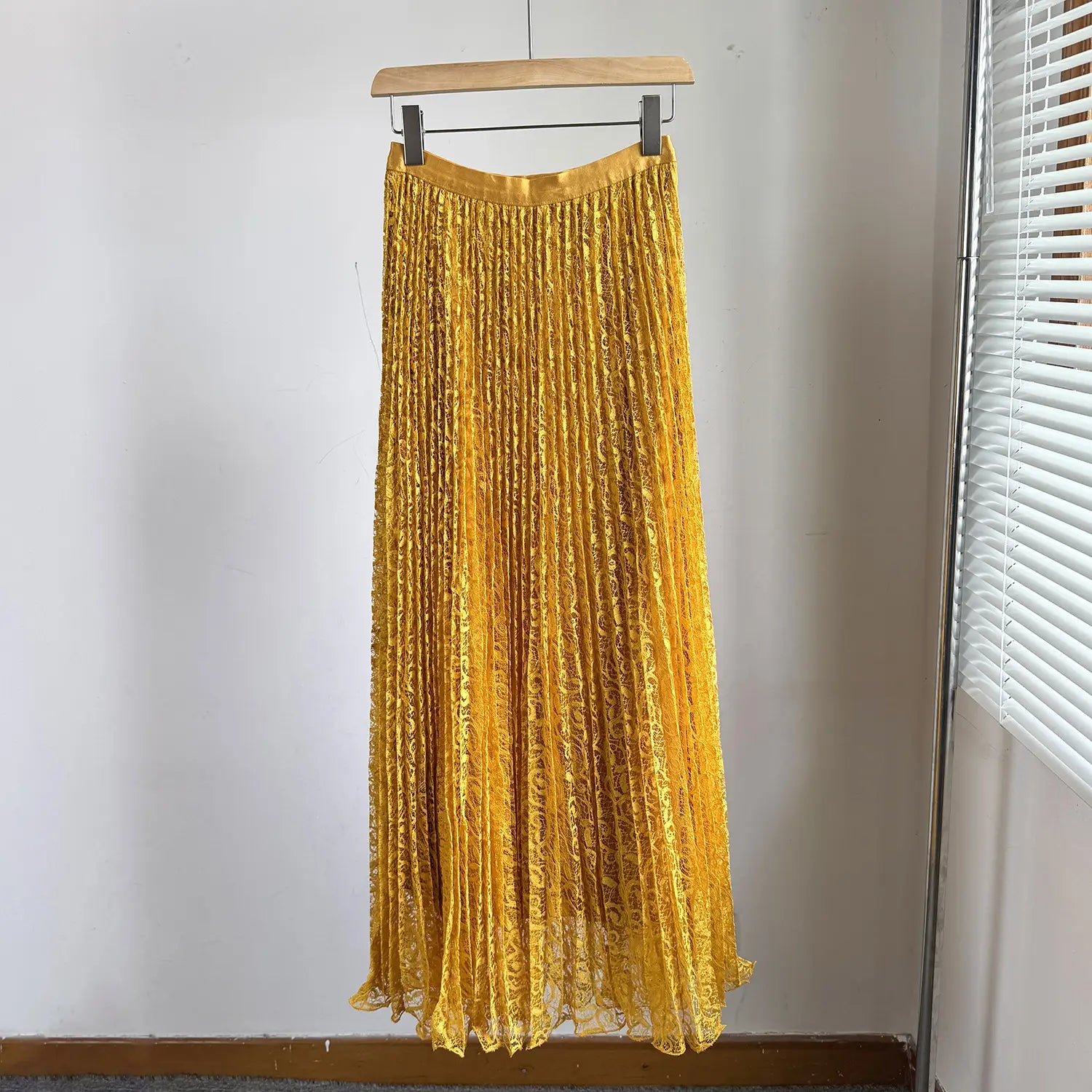 A shimmering gold high waist pleated midi skirt with delicate lace overlay and elastic waistband suitable for Y2k streetwear.