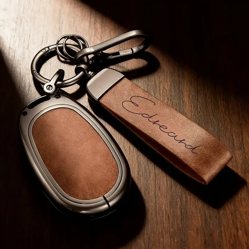 Brown leather keychain with silver metal frame engraved with the name edouard as a custom engraved leather keychain personalized gift.