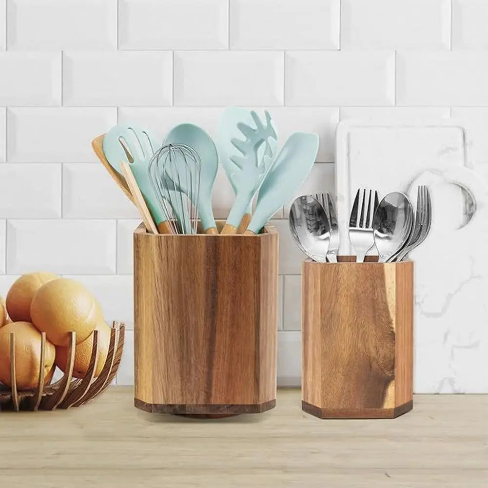 Two hexagonal wooden rotating kitchen utensil holder countertop organizers, one holding light blue silicone and wood-handled tools, the other containing stainless steel cutlery.