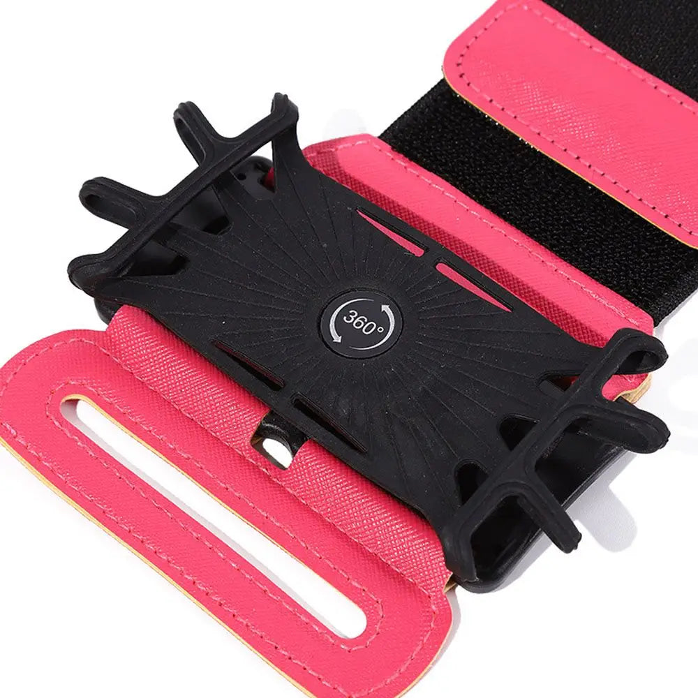 Brazalete deportivo para el brazo en color rosa y negro con un soporte para teléfono giratorio de 360 grados, diseñado para actividades de carrera y acondicionamiento físico.