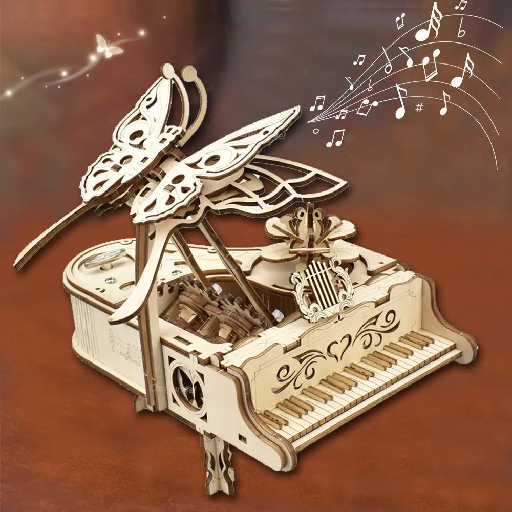 eine zarte, hellfarbene hölzerne Klavier-Musikbox-Puzzlevariante mit Schmetterlingsthema, kunstvollen ausgeschnittenen Flügeln und verziertem Ornament-Schnörkelwerk für den Zusammenbau