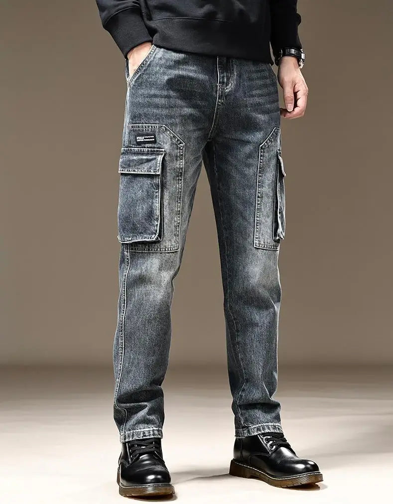 Baggy dark wash denim cargo pants featuring large flap pockets and a relaxed fit in dark-wash denim material.