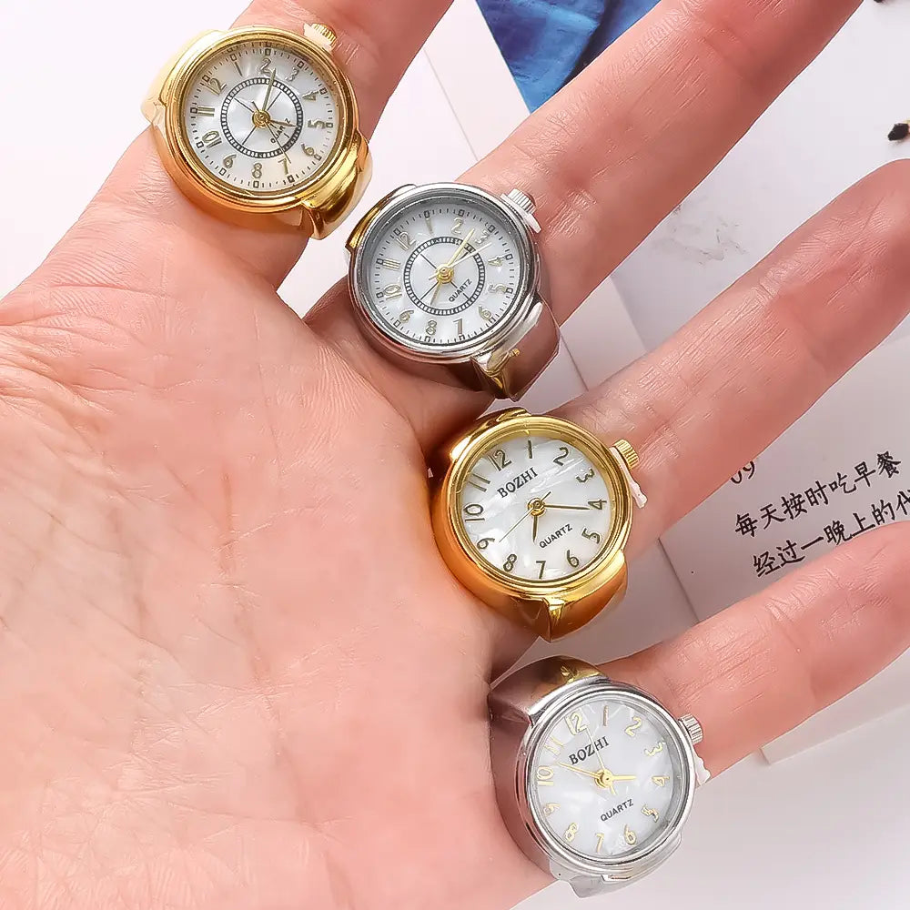 Gold and silver ring watches with white faces black numerals and quartz movements designed as unisex finger jewelry gift