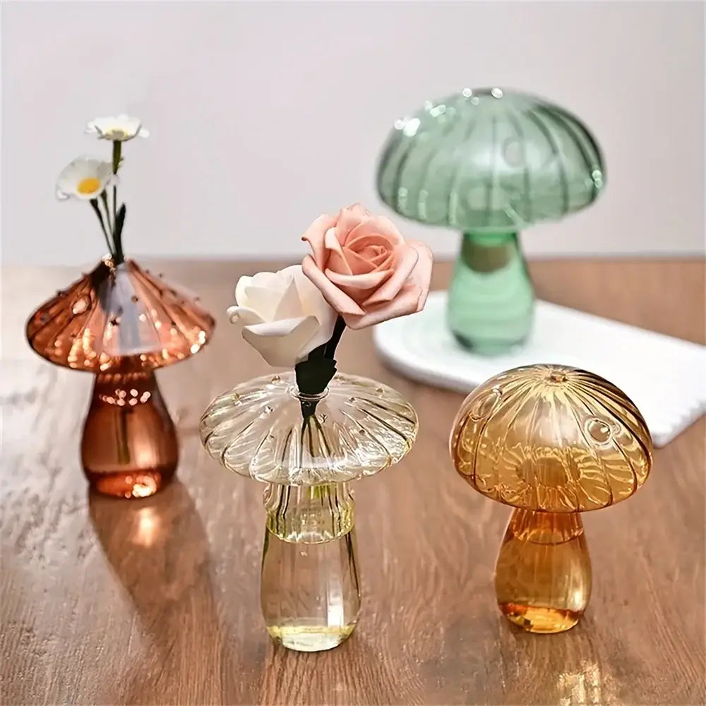 Clear glass mushroom bud vase with a ribbed cap and textured stem holding a single pink rose as a colorful Nordic plant holder.
