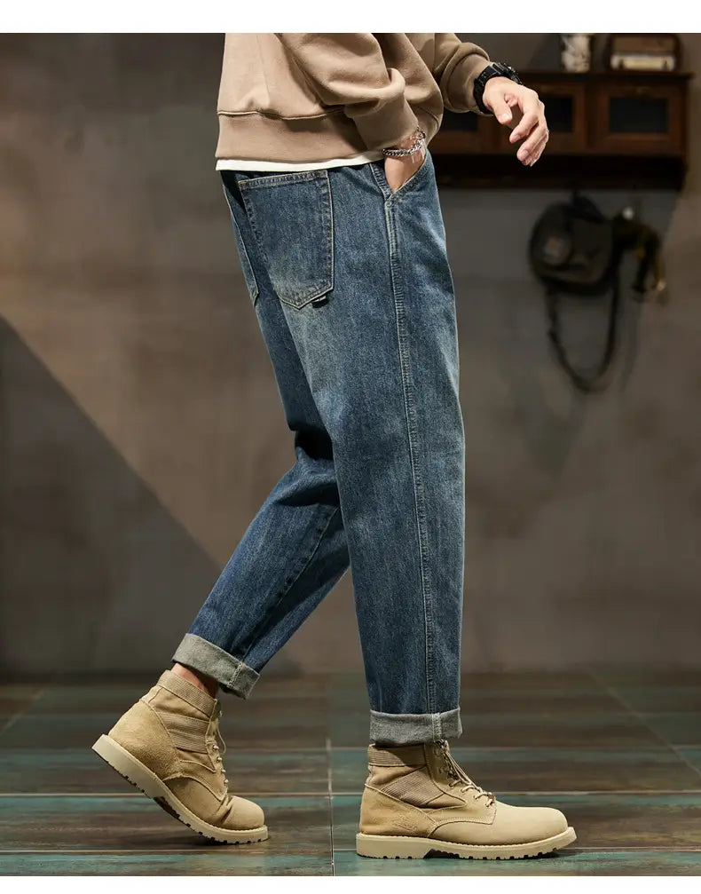 Men loose denim harem jeans in blue denim with rolled cuffs and a classic straight-leg cut made from durable cotton material.