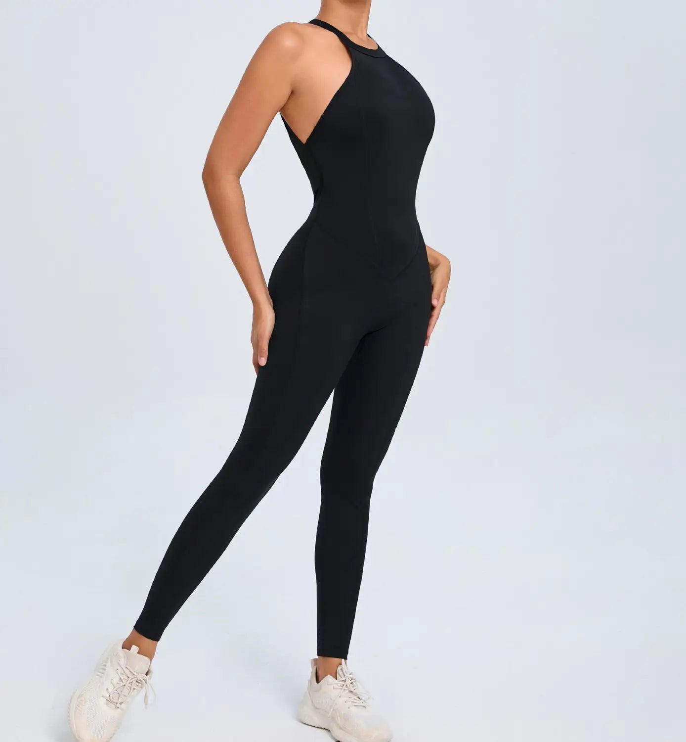 black high-necked one-piece athletic jumpsuit with sleek form-fitting design and open back shown from the back side suitable for workouts and athletic activities
