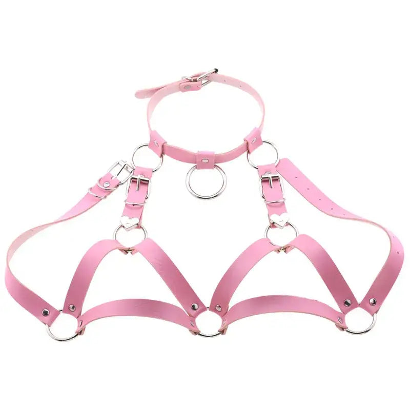 Pink faux leather goth body harness featuring silver metal rings and heart-shaped clasps as body jewelry for alternative fashion.