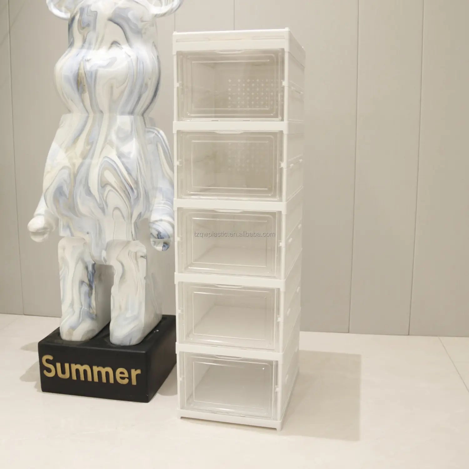 clear plastic stackable storage boxes with white frames designed as a shoe organizer for efficient storage during working time.
