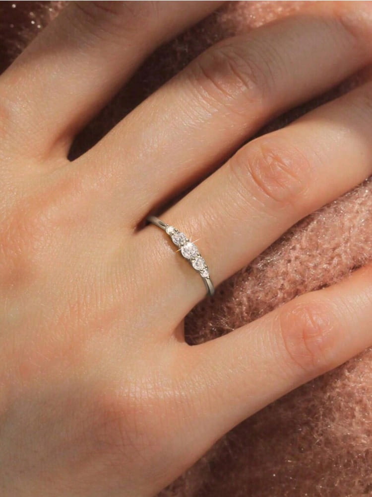 A delicate sterling silver zircon ring for women featuring a silver band with three round-cut diamonds in a classic design.