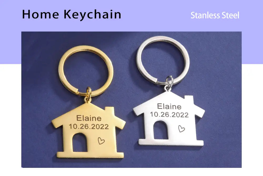 Two personalized stainless steel house-shaped keychains in gold and silver engraved with a name and date for a custom couple gift.