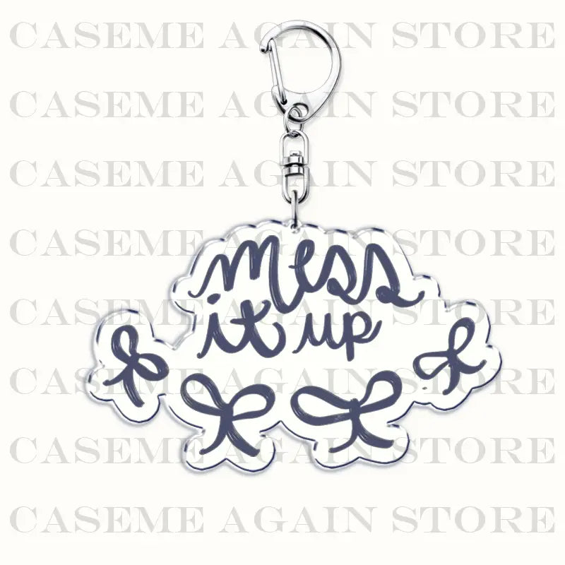 Silver metallic Gracie Abrams acrylic keychain featuring a navy blue cursive mess it up script on a cloud-shaped charm with decorative bows, ideal for anime fan gifts.