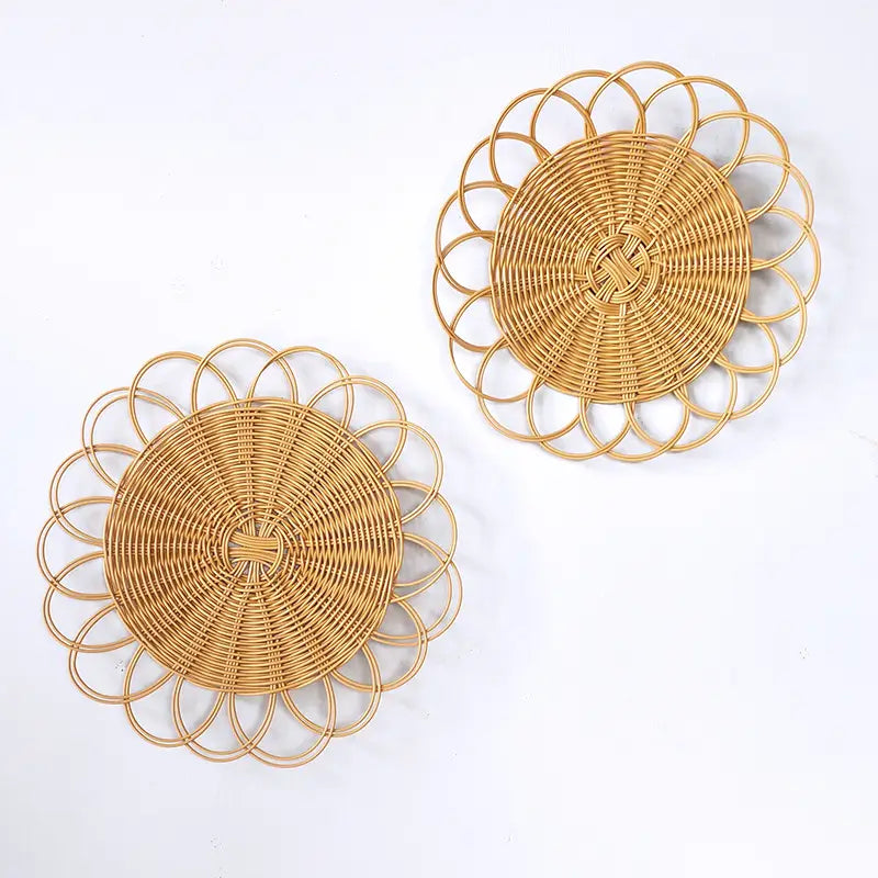 Natural-toned woven rattan flower wall hanging decor featuring an intricately woven circular design with petal-like outer rings.