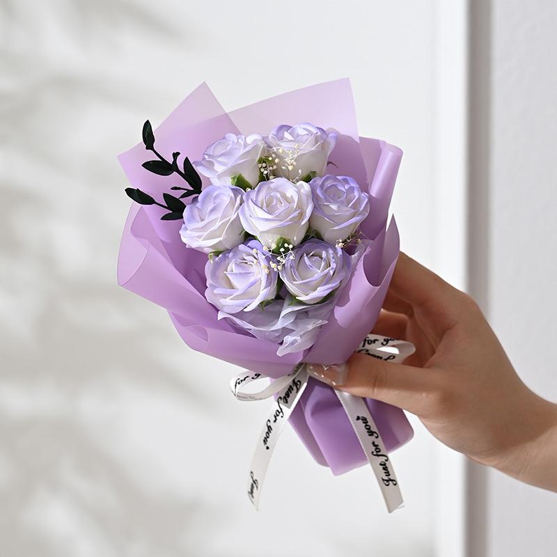 Artificial rose flower bouquet featuring delicate lavender and white soap roses wrapped in purple paper with a for you ribbon for gifts.
