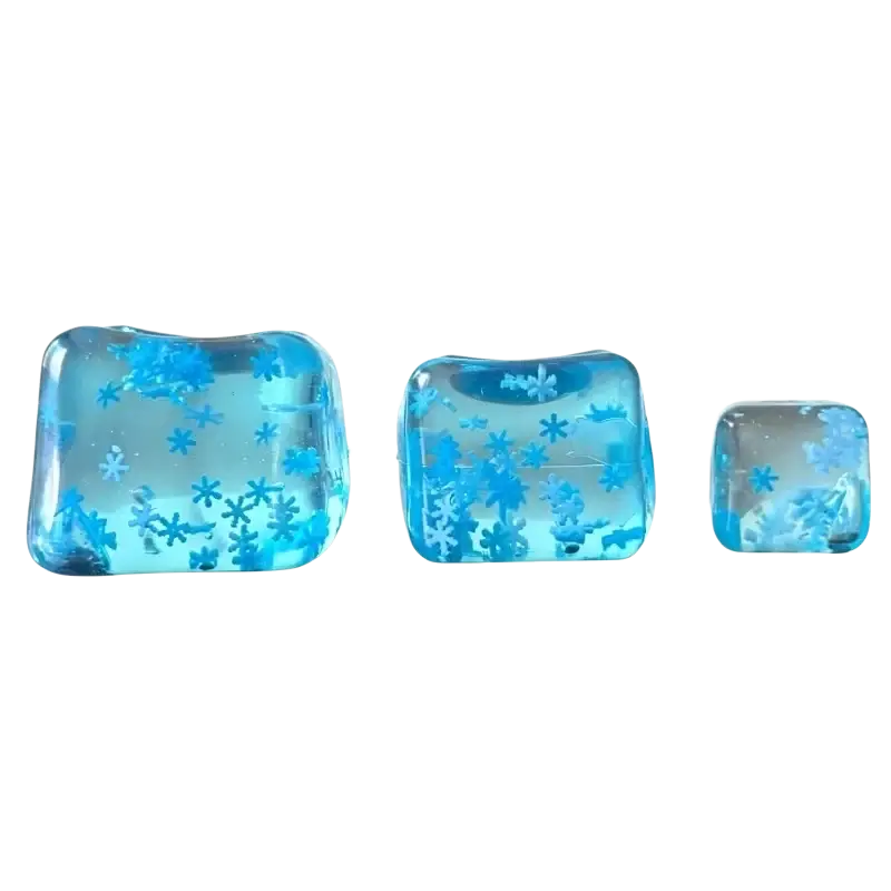 Three translucent blue ice cube stress relief toys with embedded snowflake patterns shown from a top angle