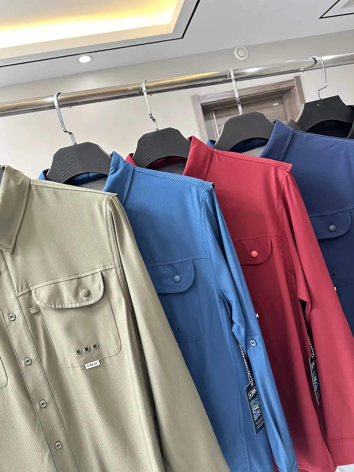Beige men’s tactical outdoor long sleeve shirt with button-up front, two chest pockets, and subtle textured fabric.
